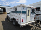 Camper on pickup truck in yard