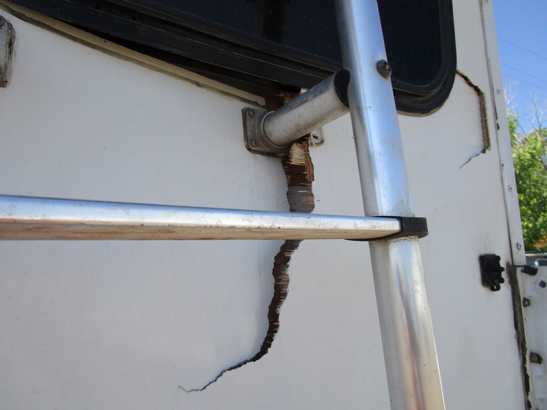 rear ladder repair - before - closeup of damage